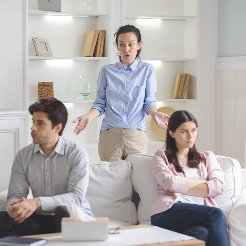 Professional therapist working with fighting young couple