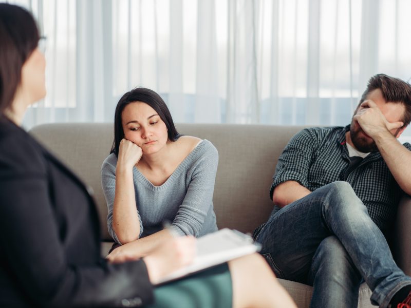 Stressed couple patients at psychologist reception