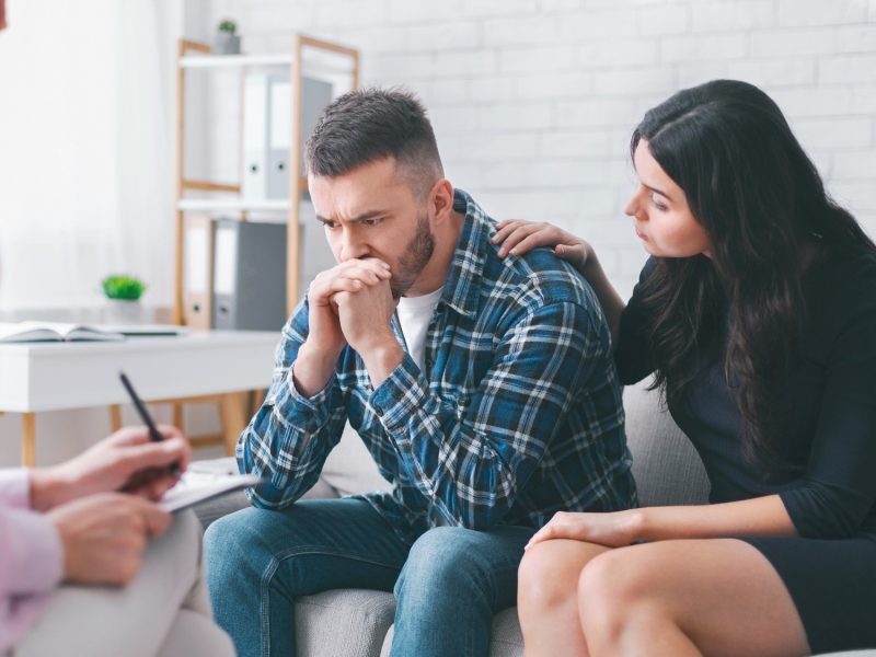 Upset Man Seeking Counseling With His Partner During Therapy Session Upset Man Seeking Counseling With His Partner During Therapy Session